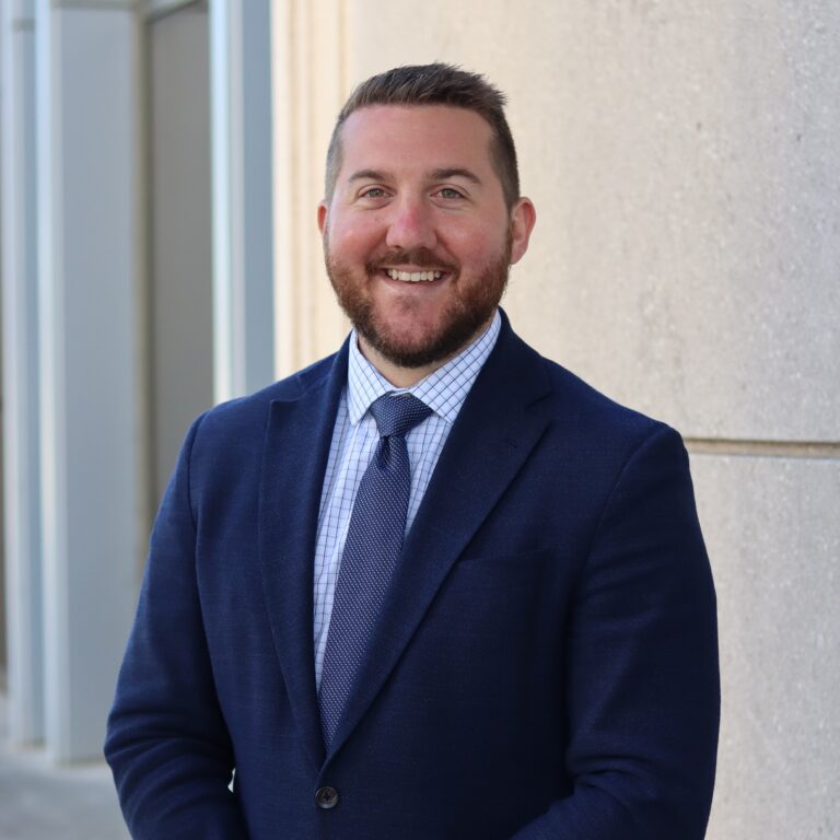 Drew Maranto dressed in a navy suit and tie