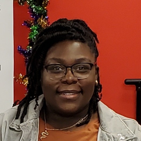 Photo of Ceyera Byrd in front of a red background.