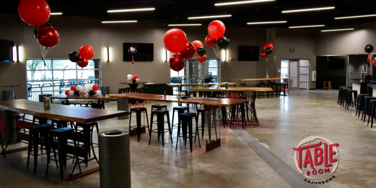 Photo of the Table Room at the Cajumdome Convention Center showing tall tables with balloons.